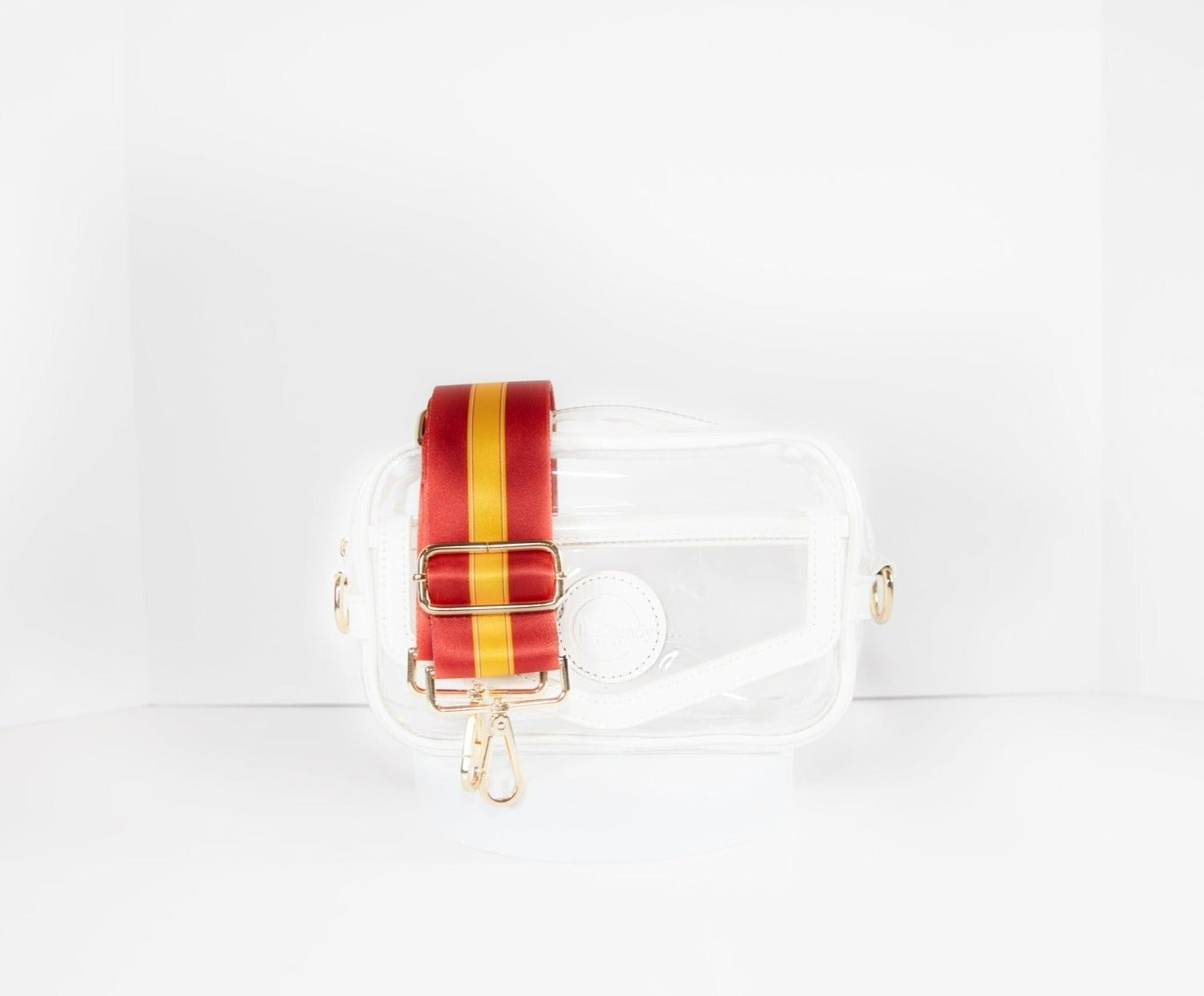 Clear stadium bag in white leather trim, front facing, with a crossbody strap in Kansas City Chiefs team colors.