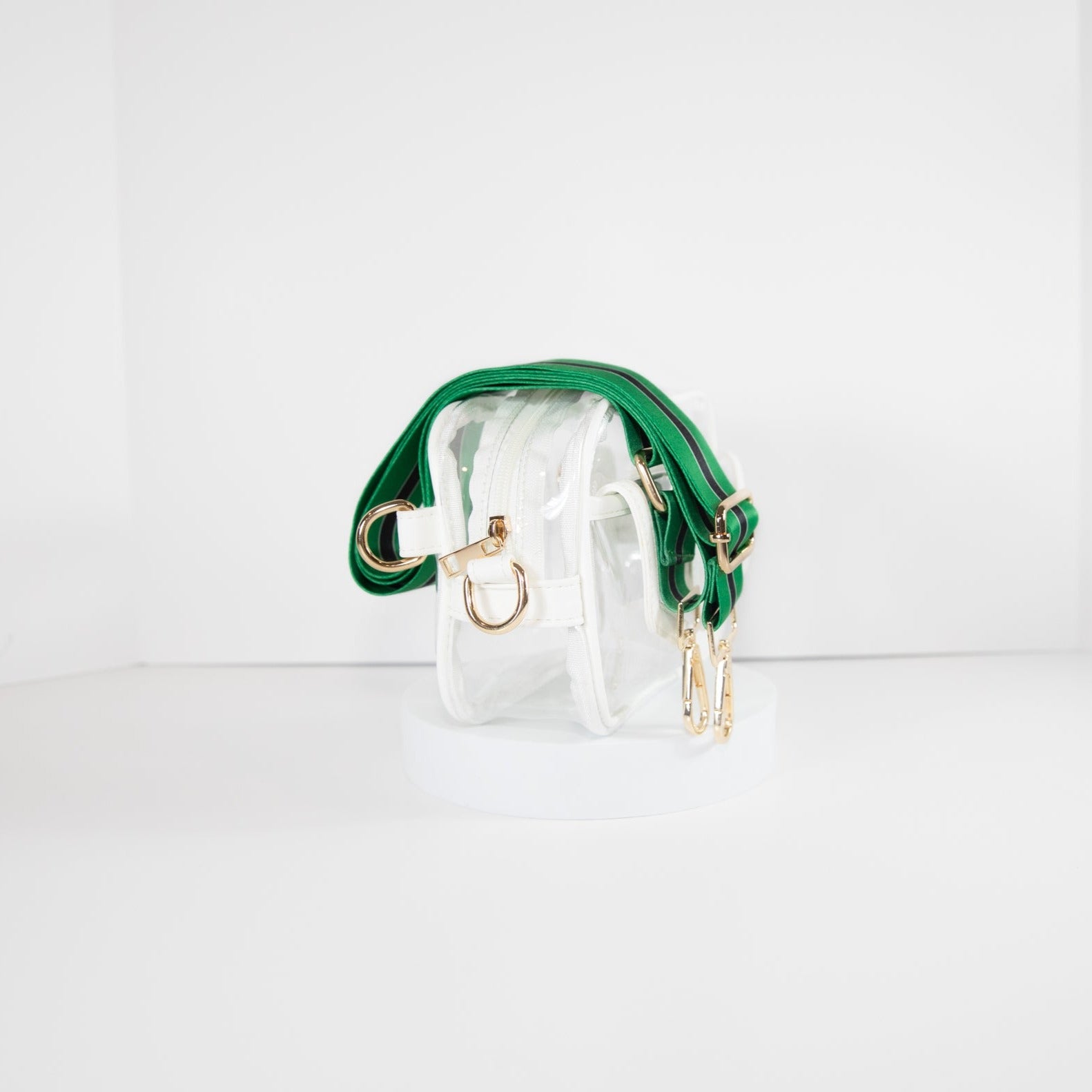 Clear stadium bag with white leather trim, side facing, with a crossbody strap in Philadelphia Eagles colors.