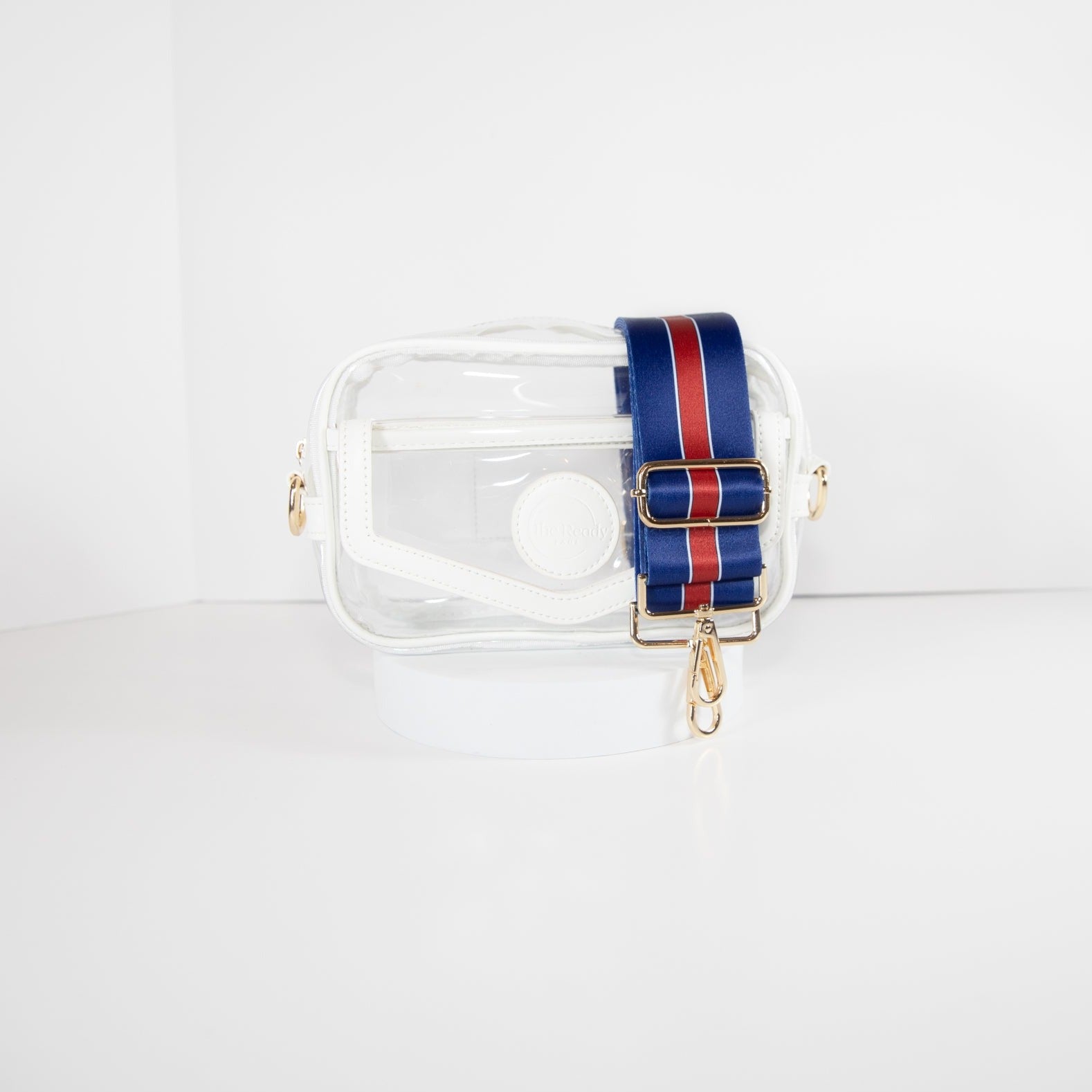 Clear Stadium Bag with white leather trim, front facing, with a crossbody strap in the colors of the New York Giants.