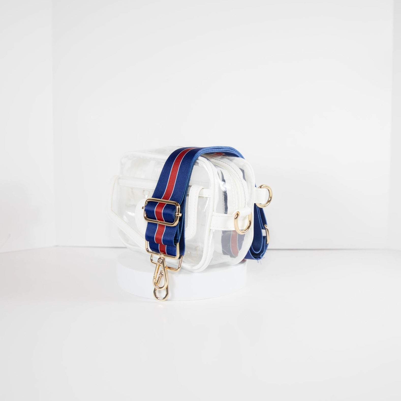 Clear Stadium Bag with white leather trim, side facing, with a crossbody strap in the colors of the New York Giants.