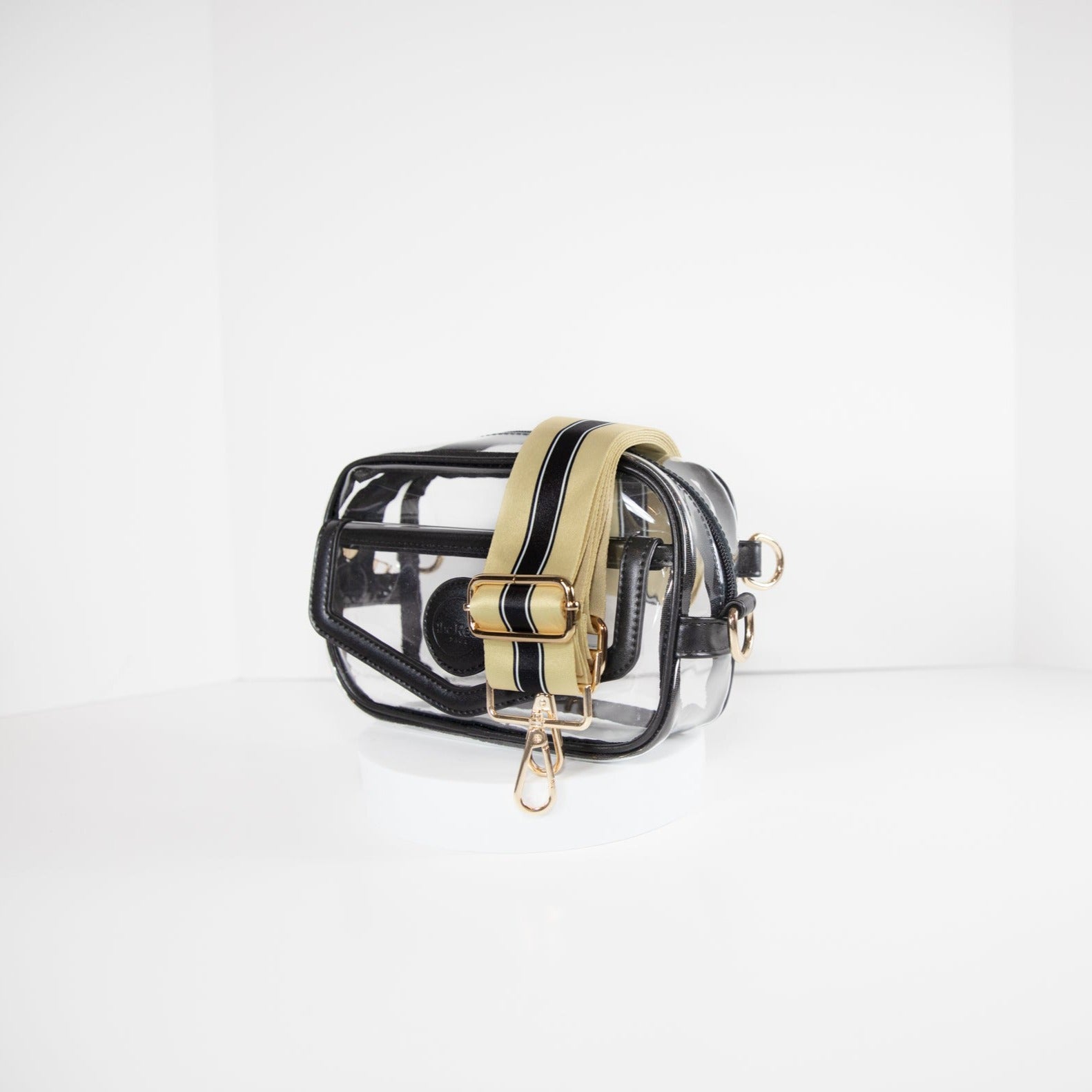 Clear stadium bag with black leather trim, side facing, with a crossbody strap in colors of New Orleans Saints.