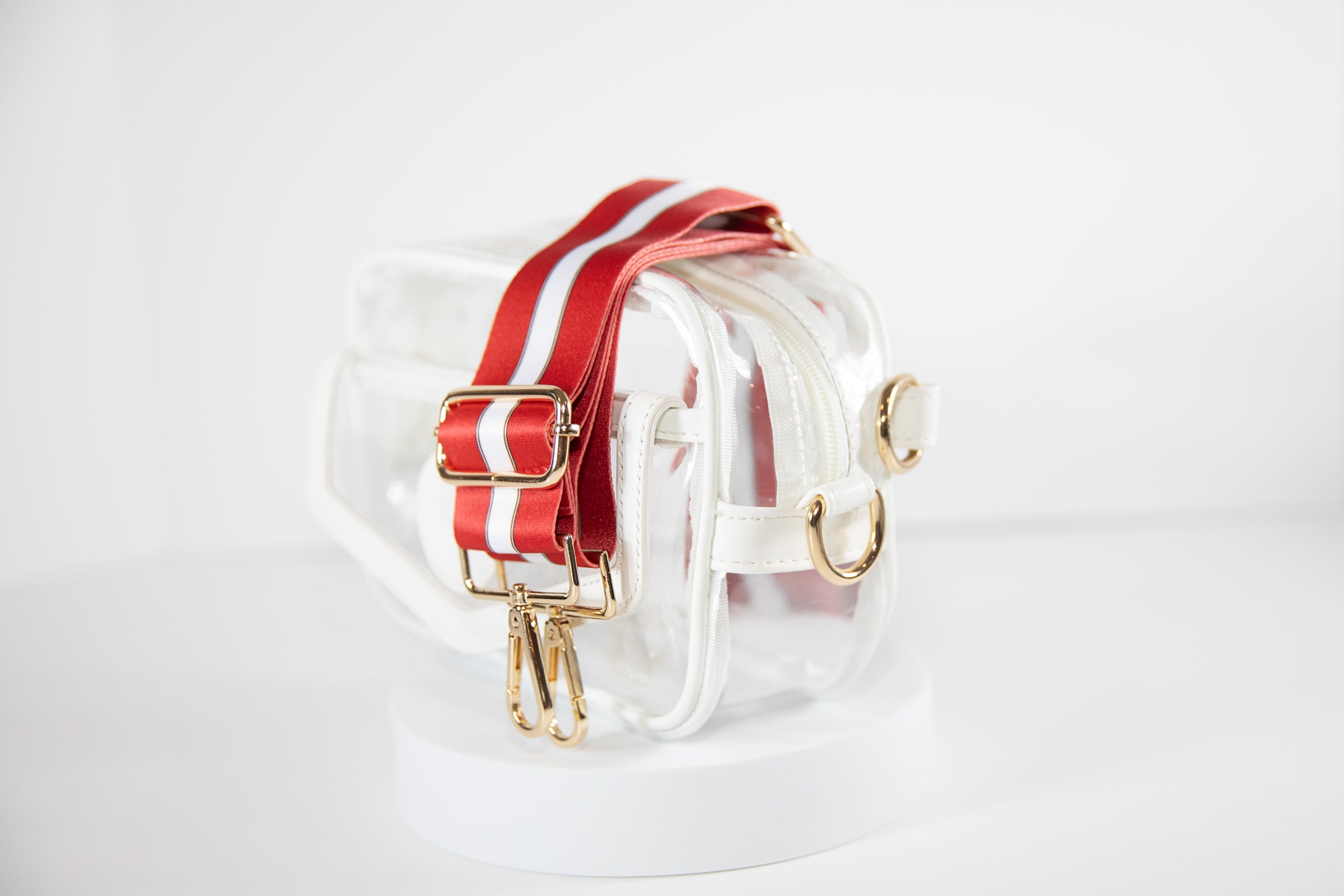 Clear stadium bag in white leather trim, side facing, with a crossbody strap in Wisconsin Badger colors.